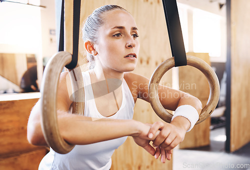 Image of Relax, gym and girl with workout ring taking a break to rest after physical activity for wellness. Tired and exhausted woman training with for core, arm and strength in body muscles.