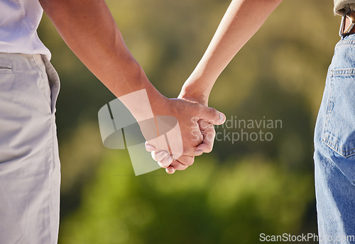 Image of Hand, love and couple with a man and woman holding hands outside in care, trust and relationship. Closeup of a male and female walking outside together for romance and affection with trust outdoors