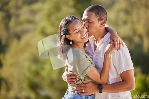 Image of Couple hug, love and happy mindset of a man and woman from Colombia kissing in nature. Female smile and male kiss of people with happiness and gratitude mindset together outdoors embracing summer