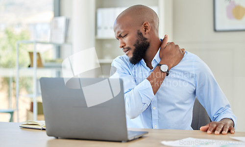 Image of Black man, shoulder pain on laptop in stress and injury suffering from overworking at home. Stressed African male holding sore muscle, tension or joint inflammation sitting with computer and work