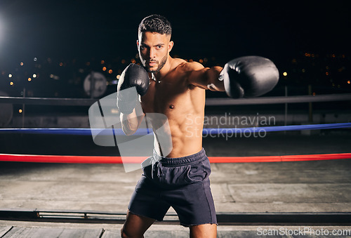 Image of Boxing ring, exercise and man or boxer in gym training for fitness, fight or workout. Sport, wellness and health with male fighter or athlete in sports club ready to train for tournament or match.