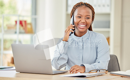 Image of Black woman on laptop, business phone call and communication at office, work or workplace. Happy corporate female on smartphone, mobile or cellphone, conversation or talking while on computer.