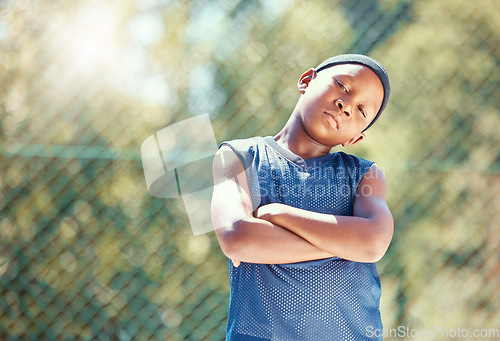 Image of Child, basketball and serious attitude with black boy standing with arms crossed ready to play outside. Proud, confident and cool kid with street swag and ready to stand up against bullying