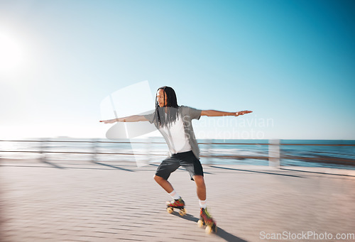 Image of Man roller skating on the promenade at the beach during a summer holiday for fun and exercise. Young, fit and healthy guy skating for a fitness workout on boardwalk in nature by the ocean on vacation