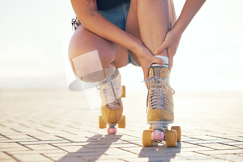 Image of Roller skate, foot injury and woman athlete check feet and ankle sports pain in summer. Exercise, fitness and skating training muscle sprain accident of a female on a workout with a bright background