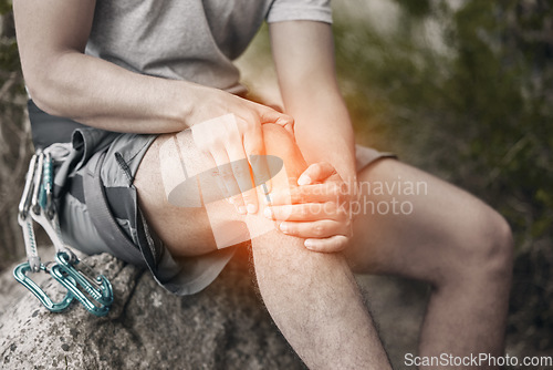 Image of Knee, injury and pain with a man sitting on a rock to take a break while out hiking, rock or mountain climbing in nature. CGI of discomfort from cramp during exercise or sports training in a forest