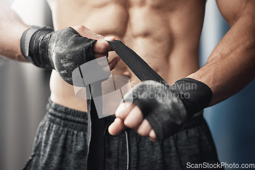 Image of Training, fitness and boxing man prepare for workout or match at gym or fitness center with hand wrap. Closeup of athletic boxer getting ready for strength, cardio and endurance kickboxing challenge