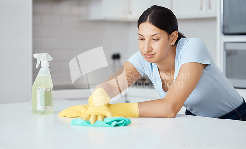 Image of Cleaner woman cleaning kitchen counter with cloth, spray bottle and rubber gloves in modern home interior. Service worker working with soap liquid, hygiene equipment or wipe surface for spring clean