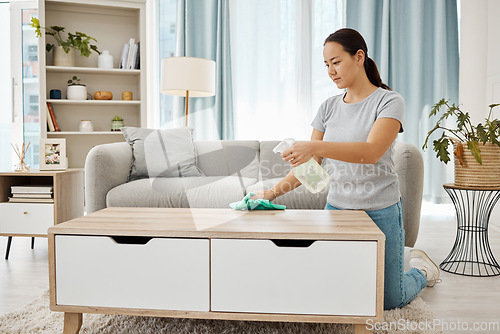 Image of Cleaning, hygiene and house task with a woman spring cleaning, sanitize living room furniture. Young female wipe and dust, enjoying fresh routine housework in a modern, germ free living space