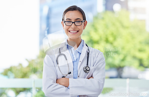 Image of Healthcare, proud and doctor woman portrait with stethoscope in a hospital with bokeh and lens flare. Care, trust and mission of a young medical professional expert or worker with wellness motivation