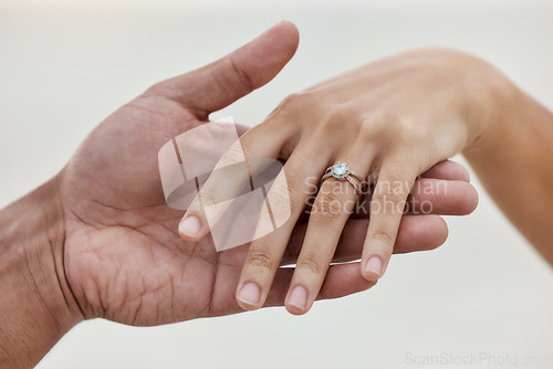 Image of Marriage, jewellery and wedding ring with hands of couple for love, celebration and announcement together. Save the date, engagement and proposal with diamond jewelry on finger of bride