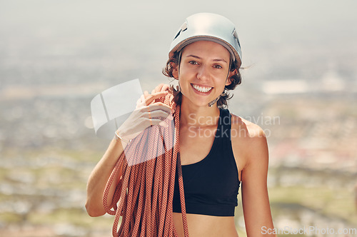 Image of Sports woman, helmet and ropes for mountain or rock climbing and hiking adventure outdoors. Exercise, fitness and extreme climber with a smile feeling adrenaline and motivated for extreme sport