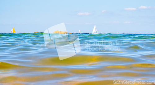 Image of Sailing boats and waves seen by a swimmer at sea level, photogra