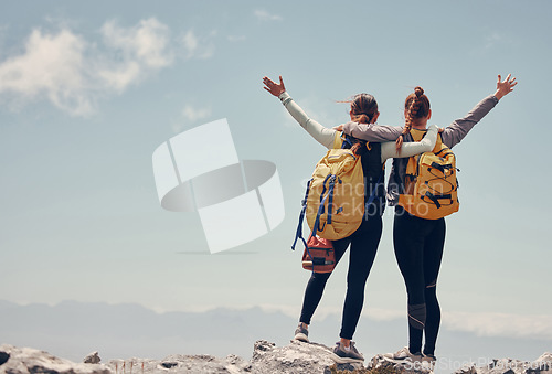 Image of Hiking friends celebrate climbing mountain peak together on rocky summit as healthy, fitness and trekking women. Success, freedom and happy climbers adventure, challenge or journey with mockup space