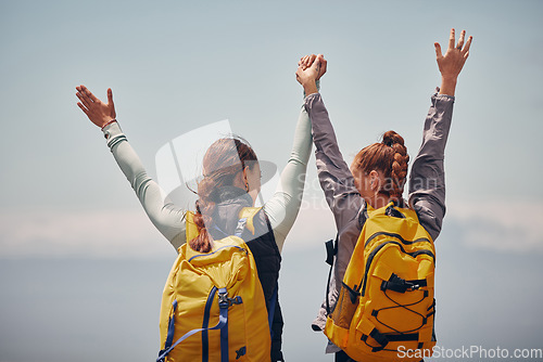 Image of Women outdoor travel, celebrate success adventure and hiking support achievement on mountain top. Blue sky landscape, best friends love nature, sunshine at peak and calm freedom of girl sisters trip