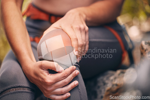 Image of Knee, pain and injury with a hiker suffering with a painful leg getting hurt while trekking or exercise training. Cgi, special effects and overlay with the hands of female hiking outside in nature