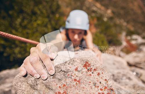 Image of Woman, hand and rock climbing with rope on mountain, hill or remote hiking for workout, training and exercise. Fitness person in energy, risk and danger sports for wellness health in nature