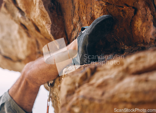 Image of Leg of man climbing rock, mountain or stone for workout, adventure or exercise. Bouldering, sport and fitness of male climber training outside, countryside or nature mountaineering, hiking or climb.