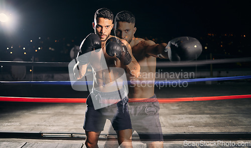 Image of Fitness, boxing and boxer in the ring training, exercise and punching with energy and power in a workout portrait. Action, performance and healthy man fighting to be a young sports champion athlete