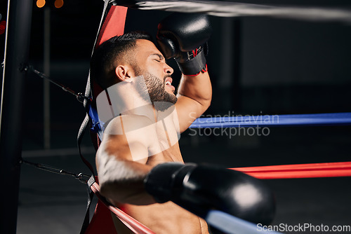 Image of Tired boxer, fitness and sports competition in boxing ring, relax during mma fight and breathing after wellness exercise training at gym. Frustrated Muay Thai athlete without energy for workout