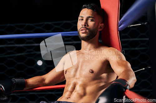 Image of Boxing, sport and workout with a male boxer in the ring for a fight, match or training. Health, fitness and exercise with a strong sports man resting between rounds of a fighting competition