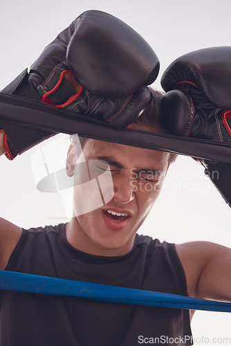 Image of Fitness, tired and injured boxing man in workout, training or exercise at wellness gym. Face, stress or in pain boxer with burnout in kickboxing or fighting ring in game, match or sports competition
