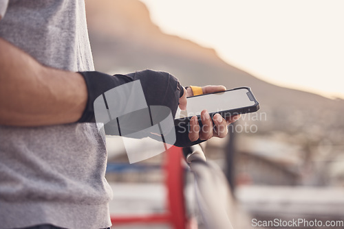 Image of Gym man, typing and phone screen at boxing fitness training practice for text conversation break. Athlete with a 5g, connection and communication tech at an outdoor sports workout venue.