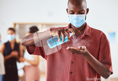 Image of Covid, hand sanitizer and business man with face mask at business meeting for healthcare safety, risk management and compliance. Covid 19, corona virus and policy black man with spray bottle cleaning