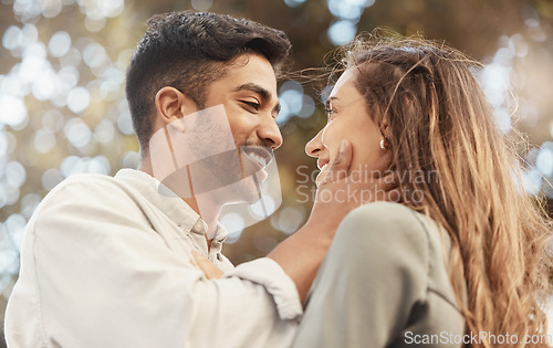 Image of Happy couple, love and commitment while outside at a park sharing a romantic moment and looking into eyes with a smile. Safe, secure and happy man and woman showing appreciation, bond and connection