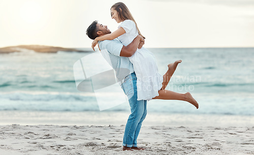 Image of Man hug and lift woman on beach celebrate love with smile near water on summer holiday, vacation or luxury sea travel. Happy couple or people, celebration together on tropical ocean sand in Bali