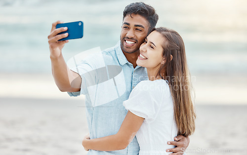 Image of Couple, beach selfie and smile for happy travel fun, freedom day and relaxing summer vacation outdoors. Photos and young people celebrate with love hug on holiday, romance together and honeymoon date