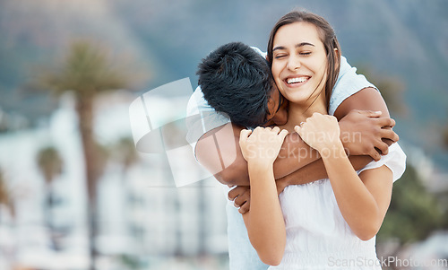 Image of Love, hug and couple in happy relationship outdoor with city bokeh for holiday, vacation or weekend outing. Care, affection and carefree man embrace woman or people with happiness together