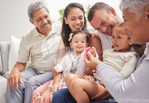 Image of Family, love and children with grandparents and kids on a sofa in the living room during a visit at home. Happy, smile and relationship with a man, woman and relatives sitting in a house together