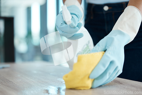 Image of Cleaning, spray bottle and hygiene with woman with gloves for housekeeping, service or disinfectant on table surface. Housekeeper, maid or housewife and cleaner, sanitary and wash at home