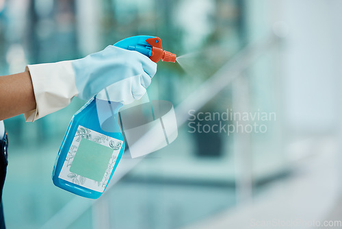 Image of Covid, cleaning and sanitizing with the hands of a woman cleaner in gloves holding a spray bottle to clean and wash an office with sanitizer. Hygiene, spraying and washing with an alcoholic liquid