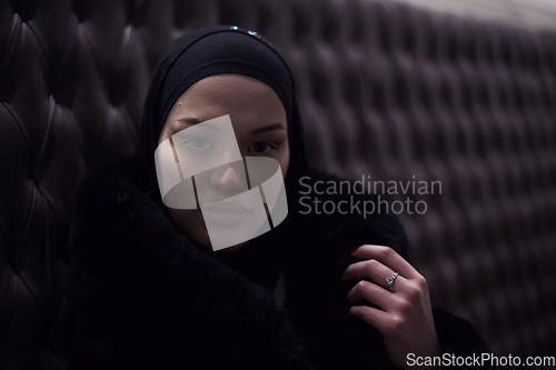 Image of happy Middle Eastern female having break take a cup of tea in restaurant