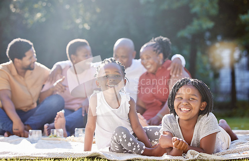 Image of Happy children, picnic and black family relax, bond and enjoy free time together in nature. Portrait of little African sisters smile in happiness for summer outdoors with parents and grandparents