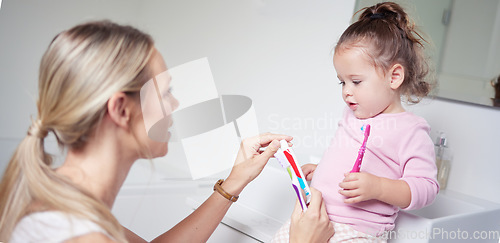 Image of Baby kid brushing teeth with mom in bathroom, morning oral hygiene and clean dental healthcare wellness. Parent with toothpaste and toothbrush teaching young toddler girl child healthy mouth cleaning