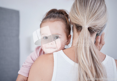 Image of Baby, communication and mom talking in phone call conversation while multitasking on business call. Work from home single mother holding a little girl, child or kid while speaking on a mobile