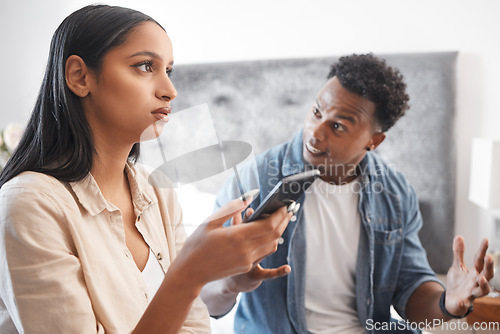 Image of Couple fight for phone social media text or cheating crisis message in bedroom at house or home. Angry, frustrated and stressed boyfriend in conflict, domestic violence and problem with girlfriend