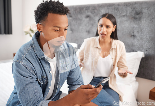 Image of Couple or black man ignore frustrated woman with phone on social media, online or internet sitting on bed. Young black people dating, angry and upset risk divorce from cheating infidelity mistake