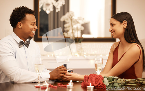 Image of Engagement, proposal ring and couple on date at restaurant with roses, gift and love celebration. Jewellery in young black man hands, woman or people together at luxury table with candles and bouquet