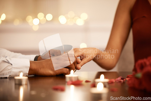 Image of Couple engagement, proposal and celebrate love with diamond ring on hand, jewelry for gratitude and marriage commitment on date. Celebration of trust, support and faith with candle, man and woman