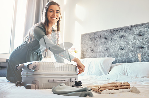 Image of Portrait, happy woman travel with luggage or suitcase in a luxury hotel bed during vacation with a smile. Woman packing bag and ready for holiday trip in a bedroom at a lodge, house or villa