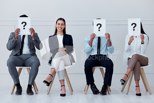 Image of Job interview, question mark and feedback with business people sitting with sign for review, recruitment and search. Why, faq and hiring with employees holding icon for opinion, vote or policy