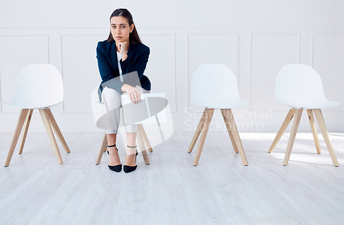 Image of Portrait business woman waiting for an interview or stress applicant sitting alone. Sad or nervous corporate professional holding resume in line for job opening, vacancy and opportunity in office