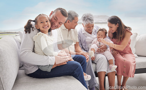 Image of Family, children and love with a girl her father bonding together at home with their relatives in the living room. Kids, parents and grandparents sitting on a sofa in their house during a visit