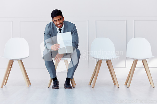 Image of Hiring, recruitment and business man in a waiting room for a corporate company job interview. Happy, smile and confident career businessman with professional cv ready for job, interview or recruiting