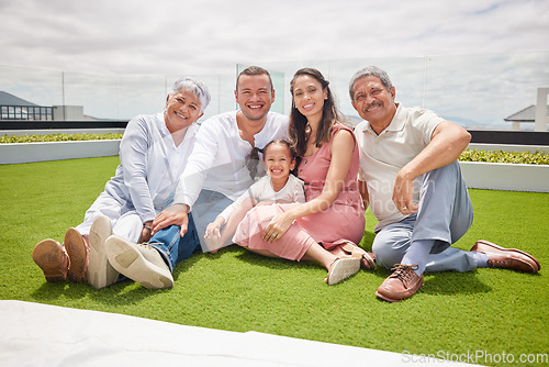 Image of Portrait of happy big family with girl, love and a smile while sitting on backyard, lawn or grass. Grandfather, grandmother and mom with dad and child or kid bonding outside home in the sunshine.
