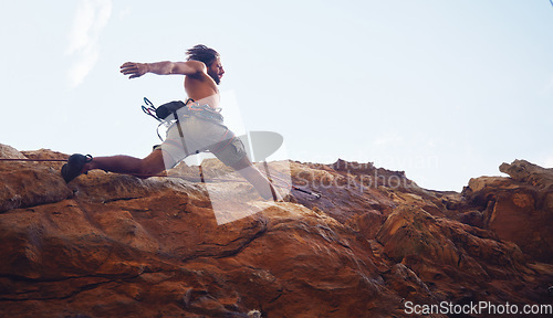 Image of Mountain, sport and climbing with a sports man running along a rocky surface for health, fitness and exercise. Workout, training and cardio with a young male climber athlete in the mountains